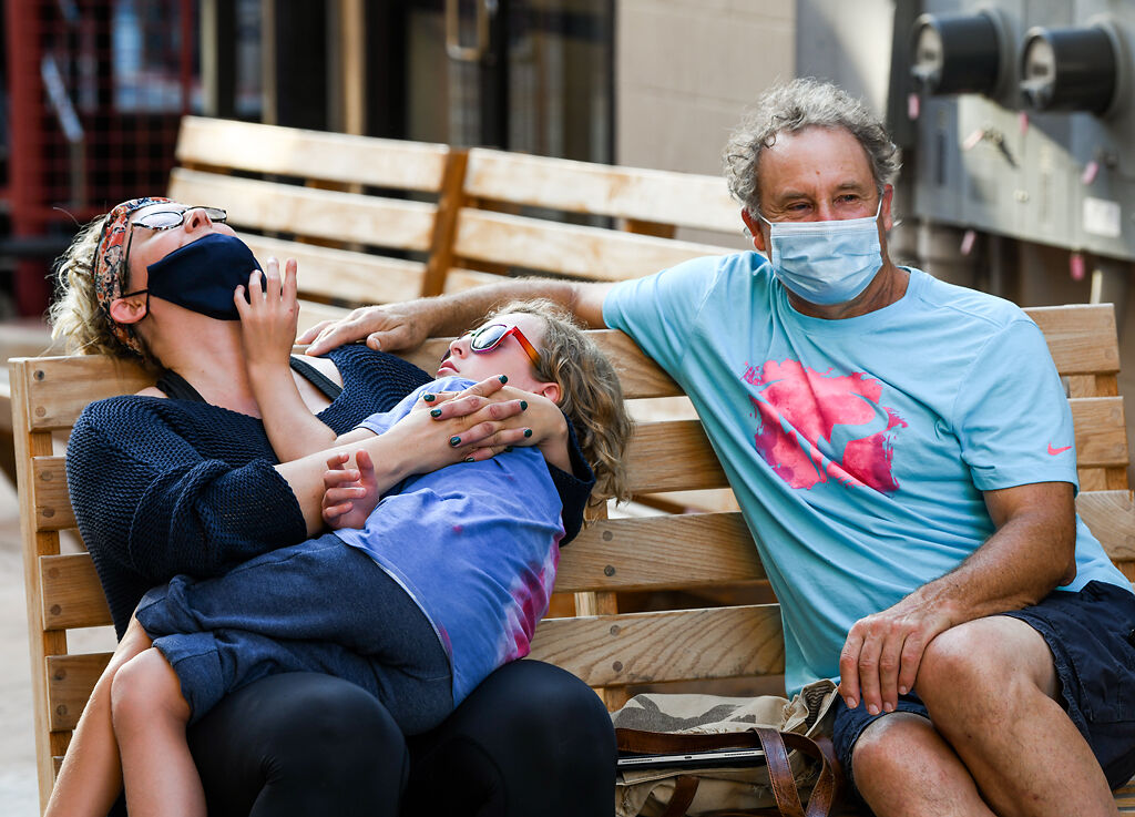 From left, Karla Klingner, her son Berik Diaz, 8, and Russ Kremer listen to reggae music